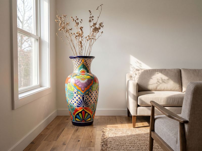 An oversized hand-painted ceramic vase displayed as a centerpiece in a sunlit living room