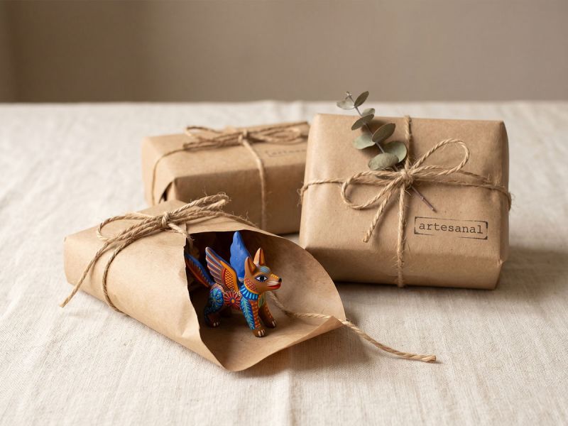 Small handcrafted gift items wrapped in kraft paper and twine