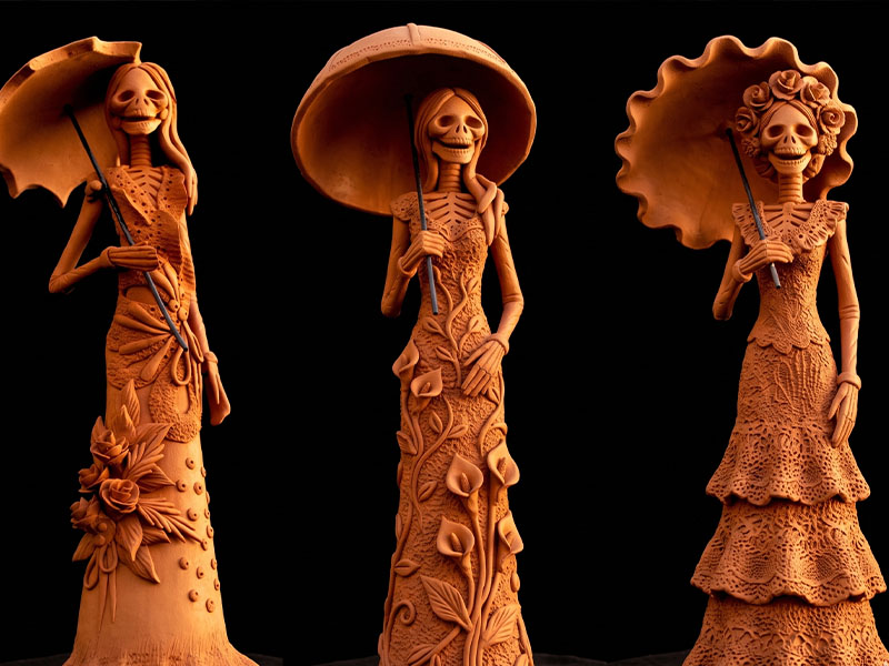 Hand-sculpted ceramic Catrina figures in elaborate painted dress displayed in a Capula workshop, Michoacán
