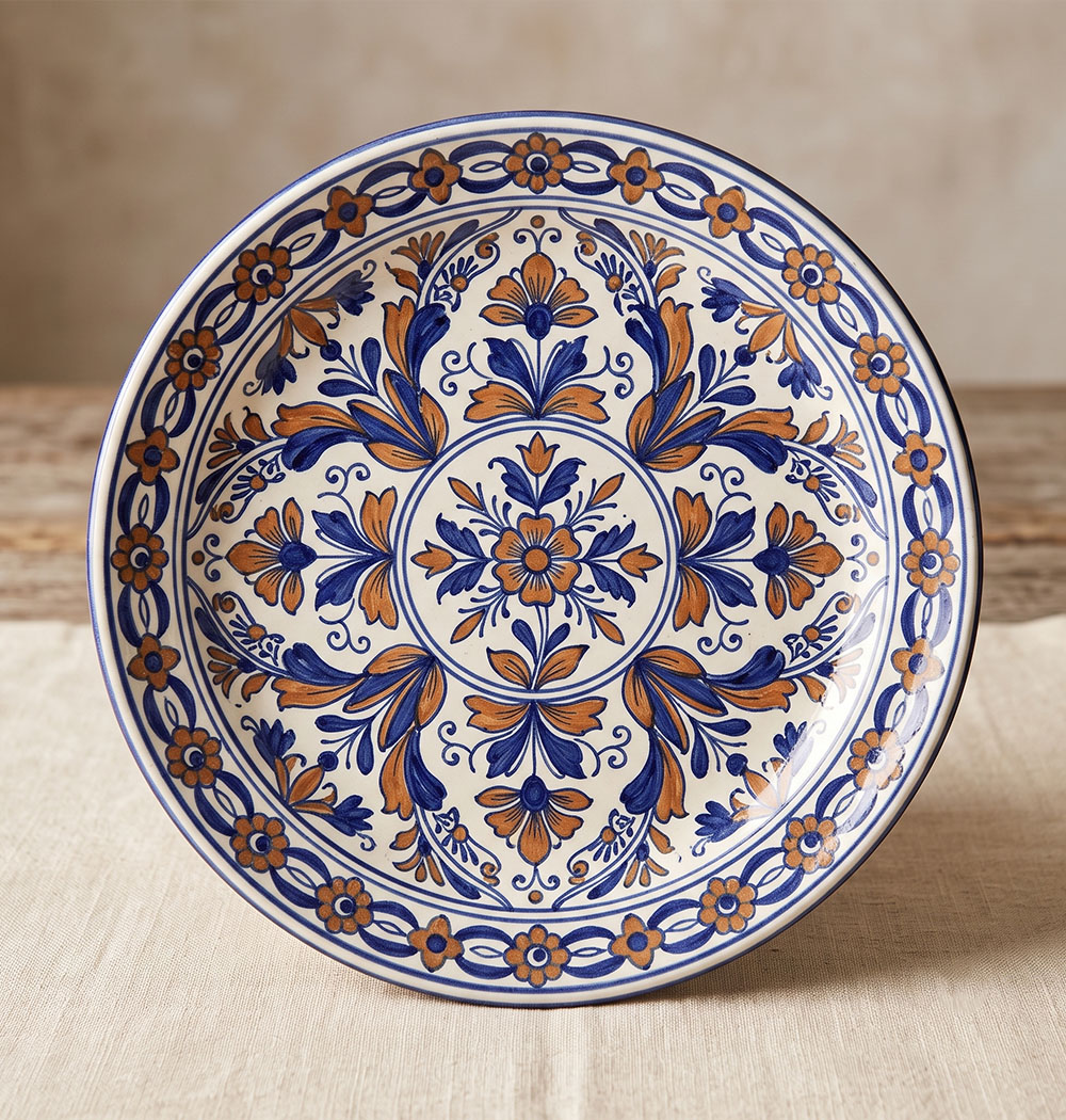 Hand-painted Talavera Poblana plate from Puebla with cobalt blue and ochre floral pattern on a white tin-glazed base