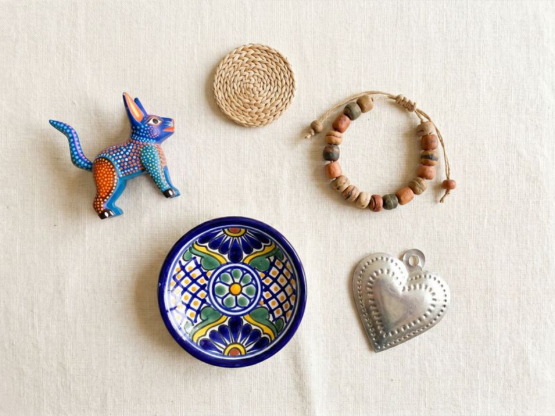 Flat lay of small handcrafted Mexican folk art pieces priced under $50