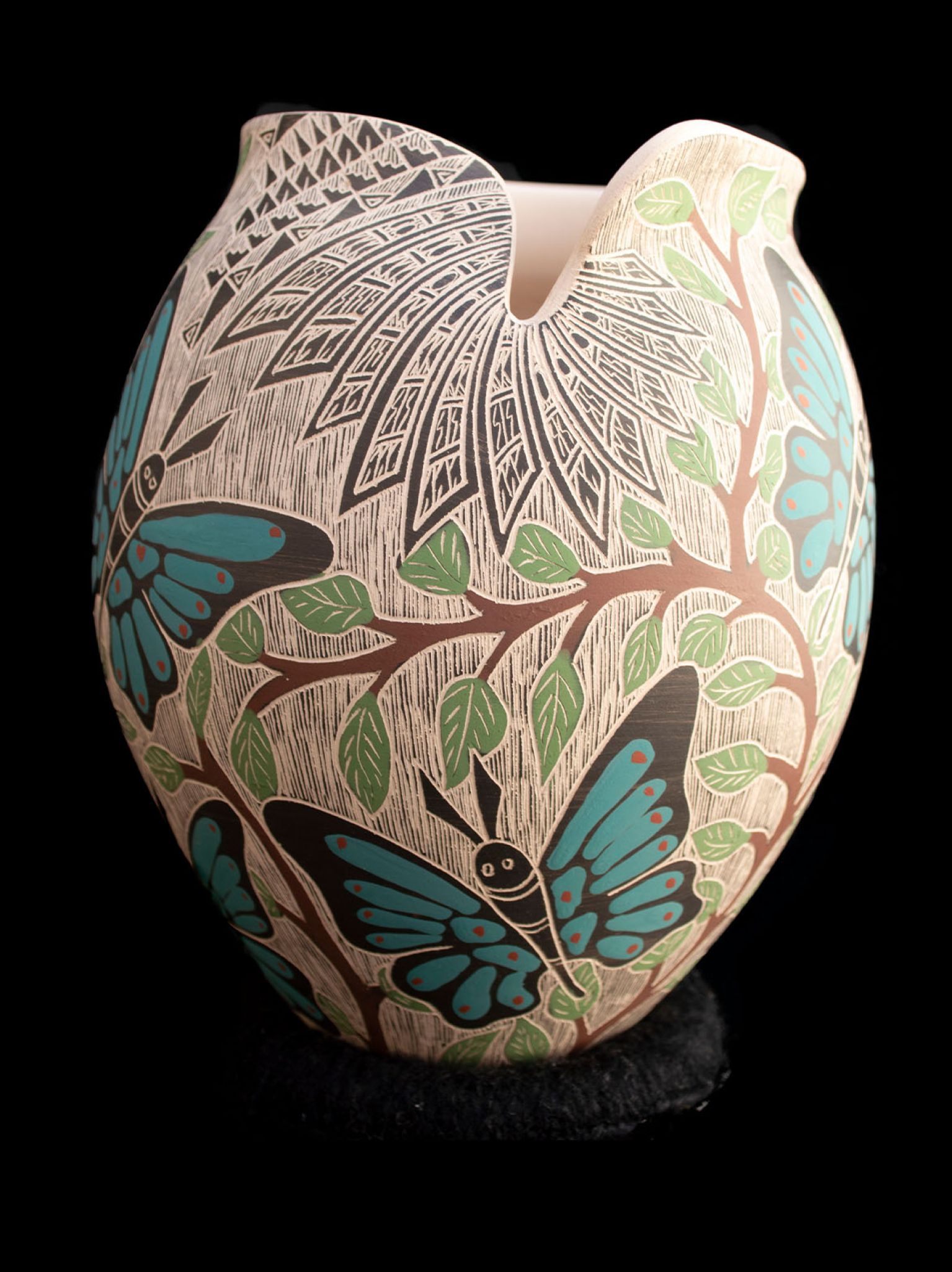 Mata Ortiz sgraffito pottery vessel with turquoise butterflies and green leaf branches by Alex Jurado, side view showing asymmetric rim